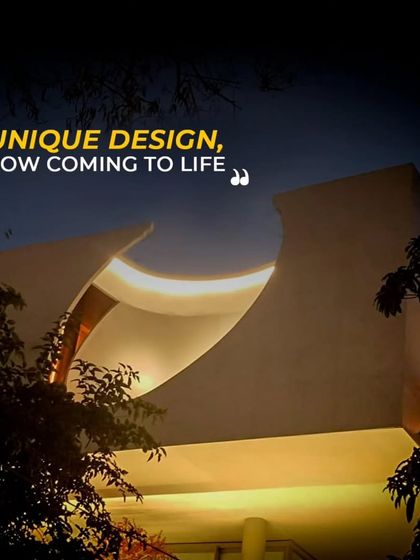 As dusk settles, the unique form of this home comes to life with carefully planned lighting. The curved roofline, framed by trees, becomes a statement of design that goes beyond simple aesthetics.