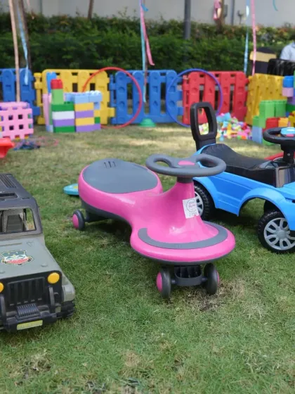 We offer a variety of ride-on cars and toys for toddlers and young children. This selection of jeeps and wiggle cars creates a mini race track area, perfect for an outdoor kids' party.