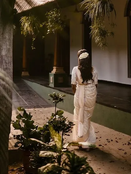 A bride walks down a corridor, the play of light and shadow creating a beautiful, cinematic feel.