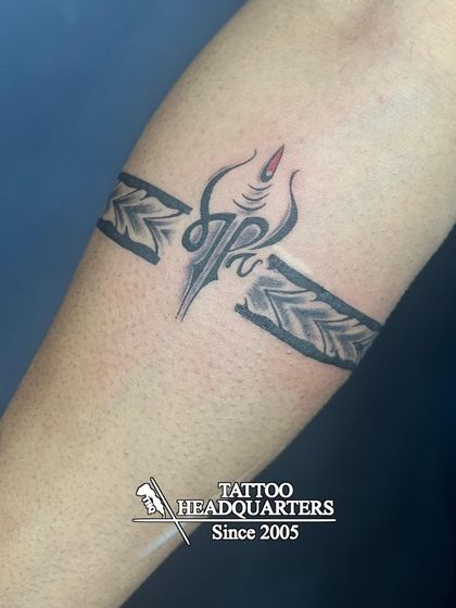 A unique armband design that is broken in the middle to feature a stylized Trishul symbol.