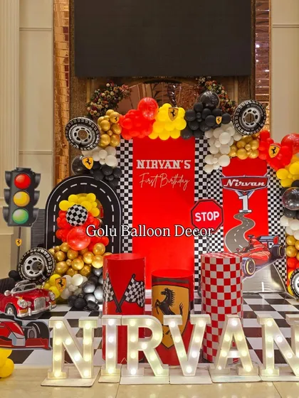 I bring high-octane fun with themes like this Ferrari race car party. The setup includes a checkered backdrop, road-themed props, traffic lights, and custom branding for a fully immersive first birthday experience.