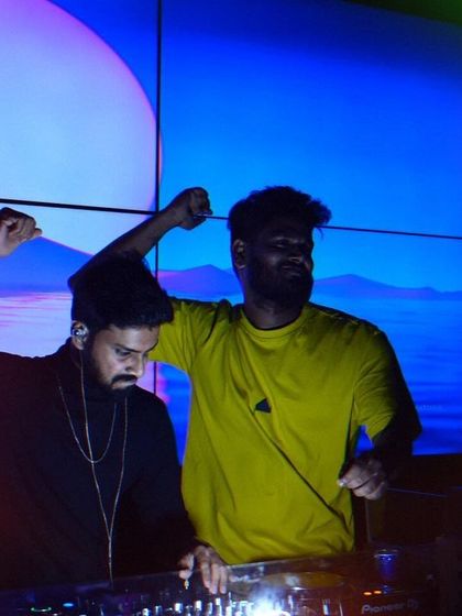 Sharing the console and the energy with a fellow artist. We are both vibing to the music in front of a serene, landscape-style visual on the screen, creating a powerful moment during the set.