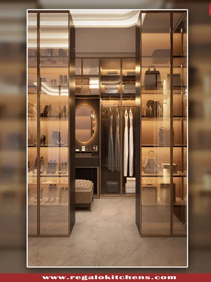 This view showcases a walk-in closet with a built-in vanity nook. The combination of open shelving for shoes and bags with closed hanging space creates a balanced and functional layout.