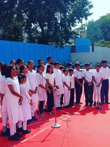 Our students performing as a choir for the 77th Independence Day celebrations at Vidyashilp schools. We provide opportunities for real-world performances to build their confidence.
