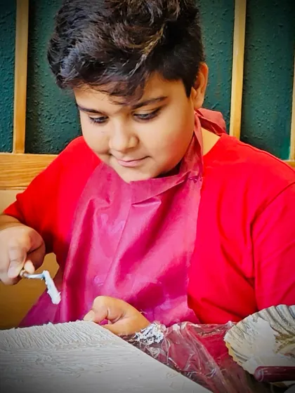 A young artist learning to use a palette knife to create texture. It's a fun, sensory experience that kids absolutely love.