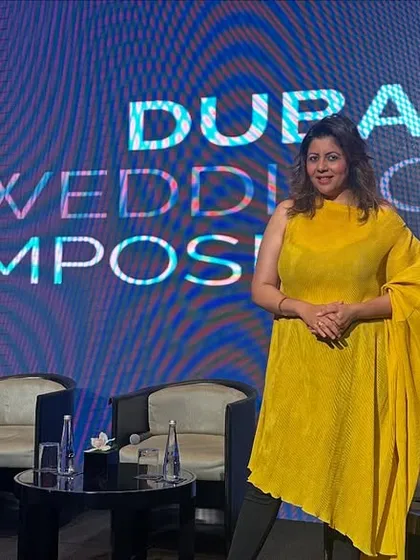 A photo of me on stage at the Dubai Wedding Symposium, a platform for exchanging ideas with wedding industry leaders from around the world.