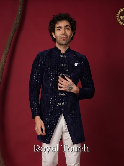 Royal touch. A full view of the navy blue sequined Indo-Western sherwani, showcasing its unique button details and sharp silhouette.