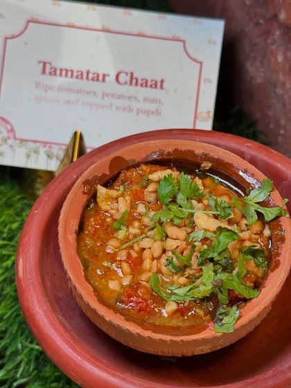Tamatar Chaat, a famous street food from Varanasi. This hot and tangy dish made with ripe tomatoes, potatoes, and spices is a flavour explosion in a traditional clay pot.