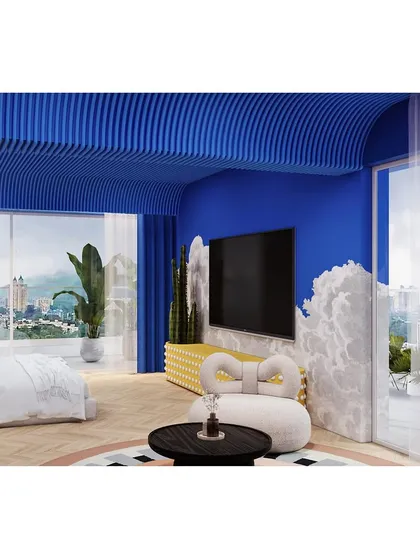 The lounge area also serves as a media room, with a large TV set against a wall where the blue sky meets fluffy white clouds.