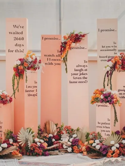 A straight-on shot of the 'Promise Pillars', showcasing the heartfelt and funny messages that tell the couple's story.