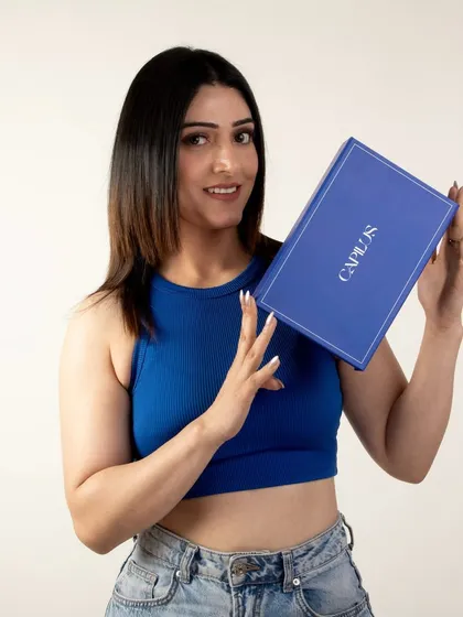 A model holding up the branded box for hair extensions, creating a positive and friendly unboxing experience.