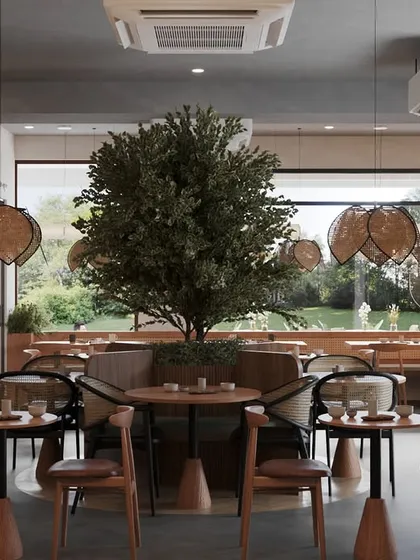 For this project, we brought nature indoors in a big way. The central tree serves as a stunning focal point, creating a serene atmosphere throughout the cafe. We designed the layout to ensure that no matter where you sit, you have a connection to the outdoors, enhanced by the large window flooding the space with natural light.