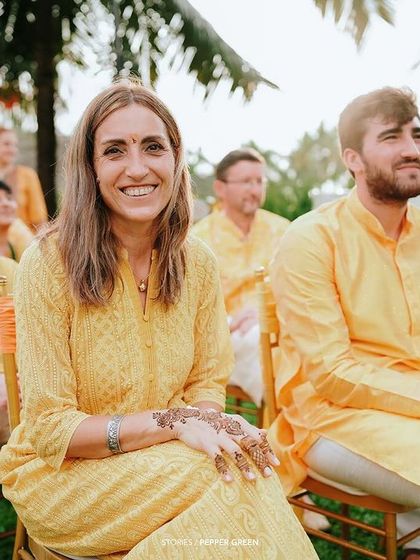 Guests enjoying the Haldi ceremony. The sea of yellow outfits creates a wonderfully cohesive and festive visual.