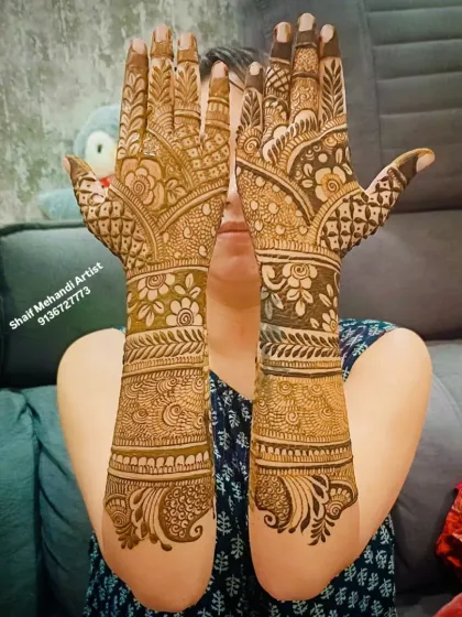 A lovely back-of-hand design with a focus on floral motifs and paisleys, extending up the arm.