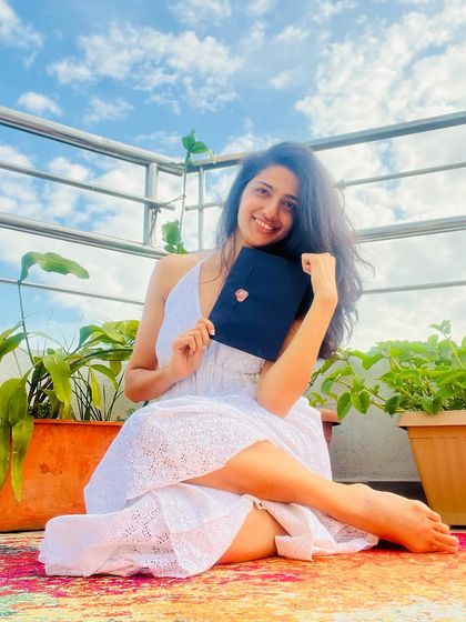 A moment of pure joy, holding a 'Love Posted' envelope under the open sky. This is the feeling I hope to send to you, a little piece of sunshine and poetry. This image announces the opening of sign-ups for my next edition.