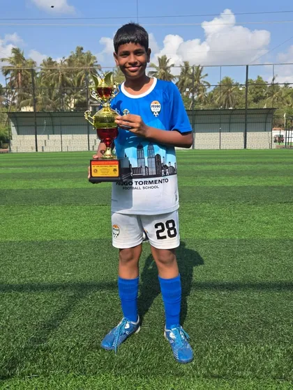 Celebrating a win with the trophy, a proud moment for this U14 player.