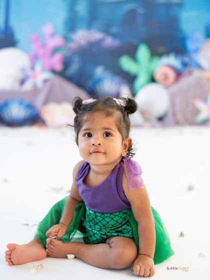 A sweet, gentle portrait of our little mermaid. Her calm expression and cute pose make this a beautiful and timeless photo.
