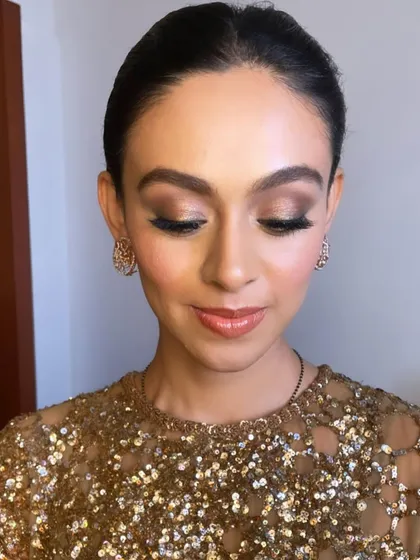 With her eyes closed, you can see the beautiful blend of neutral shimmers that create a sophisticated and eye-catching look.