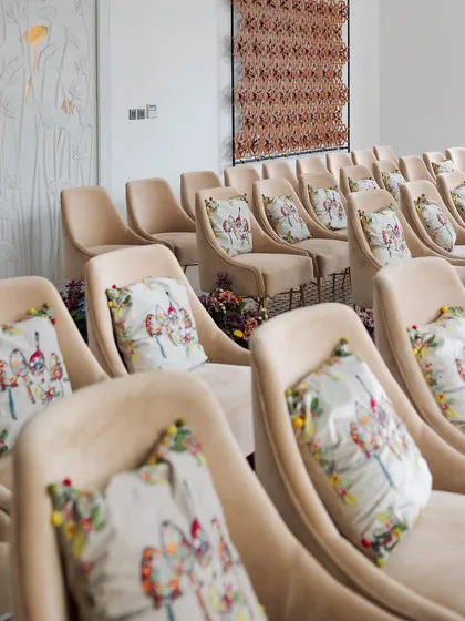 We matched subdued suede seating with custom-printed cushions featuring a bird and floral motif. I'll teach you how to use soft furnishings to carry your theme throughout the space and create a harmonious look.