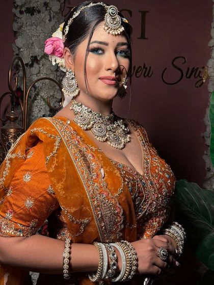 A close-up of a bride, showcasing the intricate jewelry and the flawless makeup. The nazar teeka is a beautiful touch.