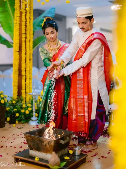 The sacred fire witnesses their union. This shot from Mugdha and Omkar's Maharashtrian wedding captures the solemnity and beauty of the Laja Homa ritual, a tradition I am deeply familiar with.