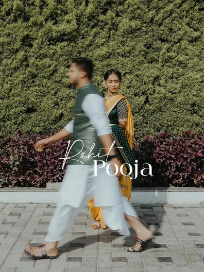 An artistic shot using motion blur to capture the couple in a dynamic way, with the groom leading the bride, set against a green backdrop.