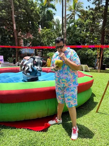 Taking a break with some coconut water next to a mechanical bull. Even in the midst of the party, gotta stay hydrated.