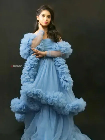 Feeling fierce in this stunning blue ruffled gown. The makeup is kept soft and pretty to balance the drama of the dress, creating a look worthy of a fairytale ball.