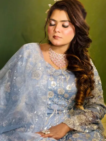 The focus here is on the soft, blended eyeshadow and the glowing skin finish. This is a perfect example of a subtle yet impactful party look.
