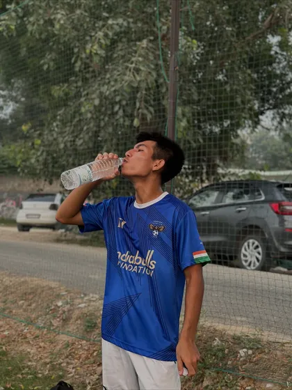 Hydration is key. A player takes a much-needed water break after an intense training session. We teach our players the importance of recovery.