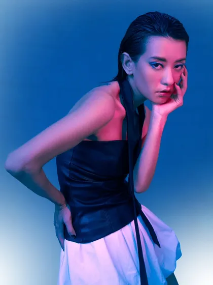 A posed, full-body shot that feels like a still from a sci-fi film. The lighting, styling, and the model's posture all contribute to this narrative.