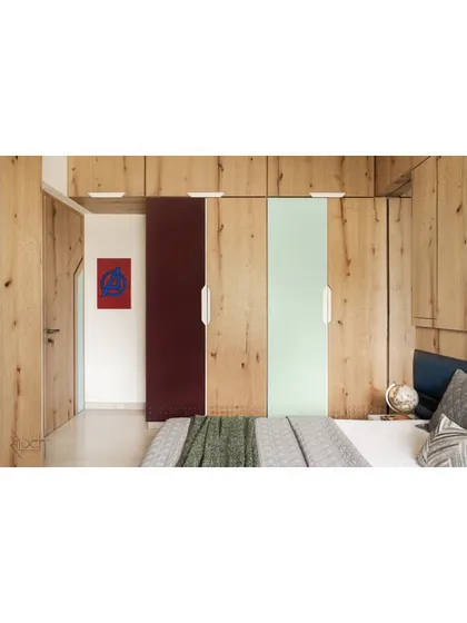 The teenager's room is painted with knotty pine veneer and pops of maroon and blue. The design is minimal yet playful, reflecting the personality of a 15-year-old.