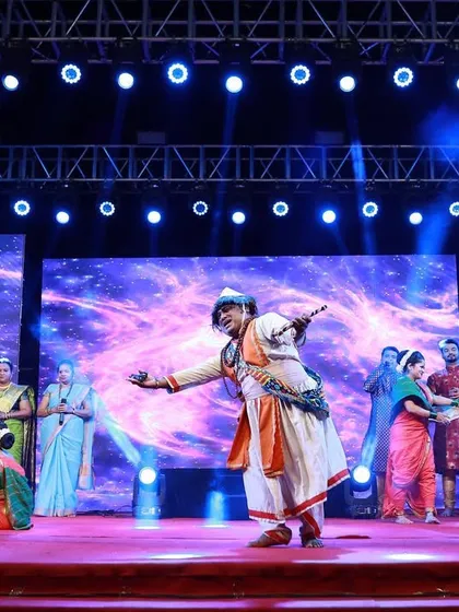 A dancer captured mid-performance on a stage I designed. The background features abstract blue visuals on the LED walls, while the stage lighting ensures the artist is always the center of attention.