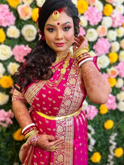 A full view of this stunning Bengali reception look. The makeup, hair, and traditional saree come together to create a look of pure elegance and grace.