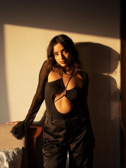 A beautiful and serene portrait using natural window light. The soft shadows and the model's calm expression create a peaceful and intimate mood.