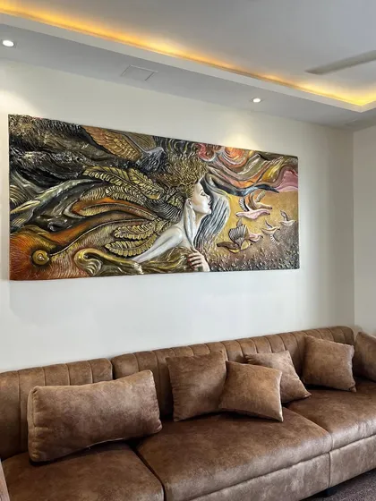 I call this mural 'Self Love'. It's a large, horizontal fibre art piece designed to hang above a sofa, depicting a woman surrounded by flowing, natural elements.