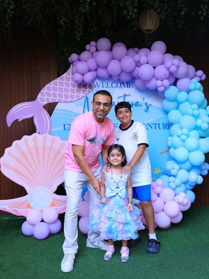 A family photo capturing the fun of the mermaid-themed celebration. We love seeing the whole family get into the party spirit.