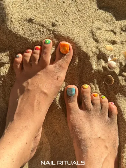 Vacation toes ready for the spotlight. This image captures the fun and vibrant vibe of our custom pedicure art, perfect for any sunny getaway.