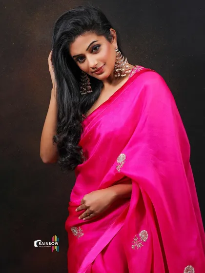 A graceful pose by Priyamani, highlighting the flow of her hair and the elegant drape of the saree.