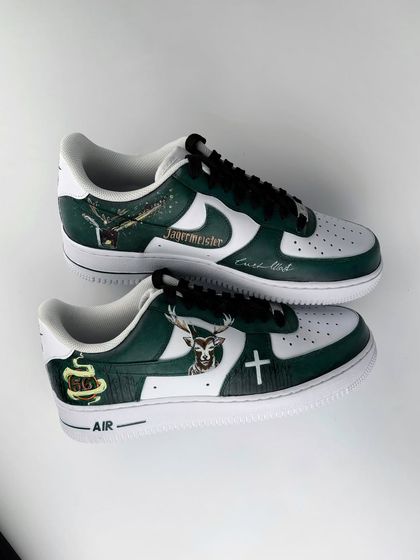 A complete overview of both shoes in the Jägermeister pair. This image captures all the different design elements together, from the logo on one side to the stag emblem on the other.