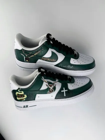 A complete overview of both shoes in the Jägermeister pair. This image captures all the different design elements together, from the logo on one side to the stag emblem on the other.
