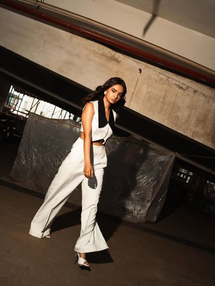 The tilted angle and strong shadows in this shot add a dynamic and slightly gritty feel to the fashion portrait.