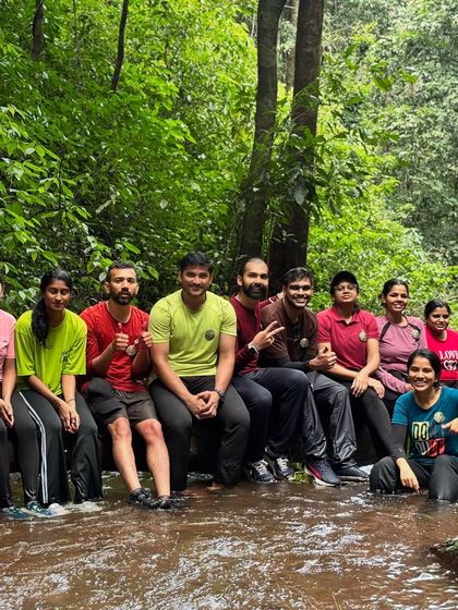 The group takes a rest, sitting by a stream on the Kodachadri trail.