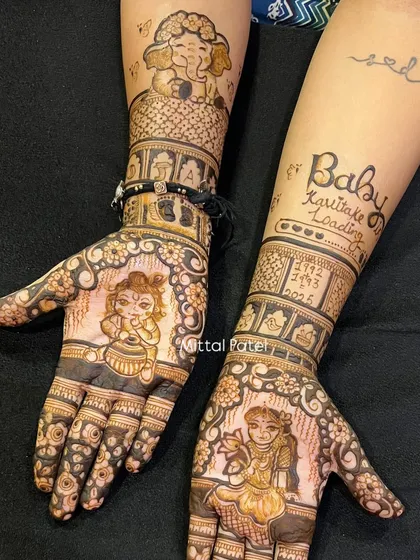 A creative take on baby shower mehndi with divine blessings. This design incorporates figures of baby Lord Krishna and baby Lord Ganesha, blending spirituality with the celebration of new life.