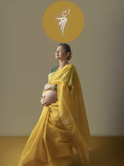 A duplicate of image 19, this photo captures the mother to be in a moment of tranquility, embracing her bump while bathed in warm light, a beautiful portrait of traditional motherhood.