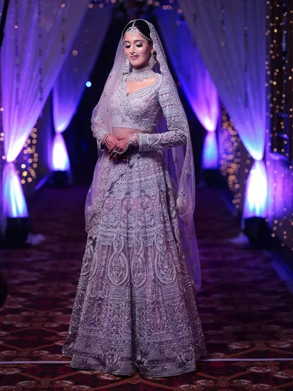 Another full-length view of the bride, showcasing the sheer elegance of her outfit and the stunning diamond jewellery available for rent.