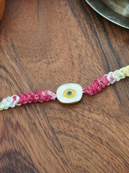 My yellow Evil Eye Rakhi. A bright and cheerful way to send good vibes and protection.
