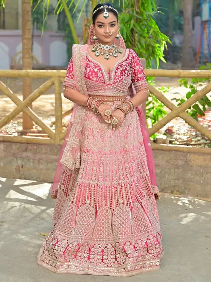 A confident pose from the bride, showcasing her stunning outfit and flawless makeup.