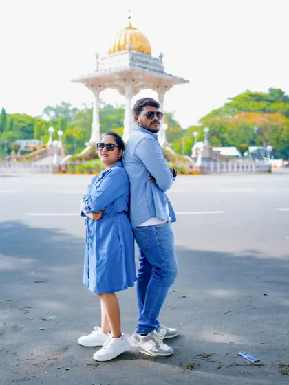 A cool back-to-back pose with the Mysore Palace in the background. This is a great way to capture a famous landmark in a fun way.