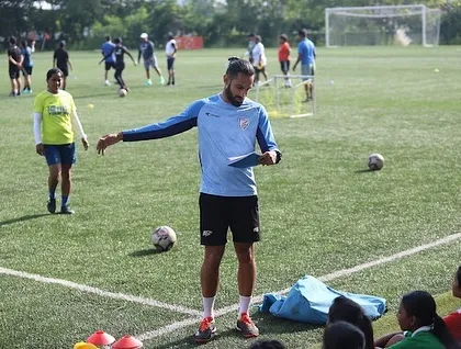 Our coaching involves clear instruction and planning. This photo captures a moment of teaching on the field during the FIFA Women's Development Programme.